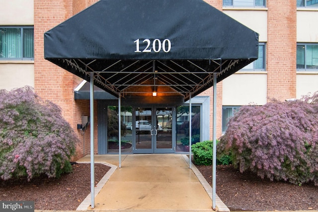 1200 S Arlington Ridge Rd Unit 205, Arlington, VA 22202 - view of exterior entry with french doors, brick siding, and stucco siding