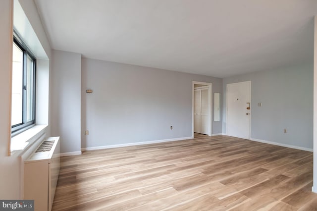 1200 S Arlington Ridge Rd Unit 205, Arlington, VA 22202 - spare room featuring plenty of natural light, light wood-style flooring, and baseboards