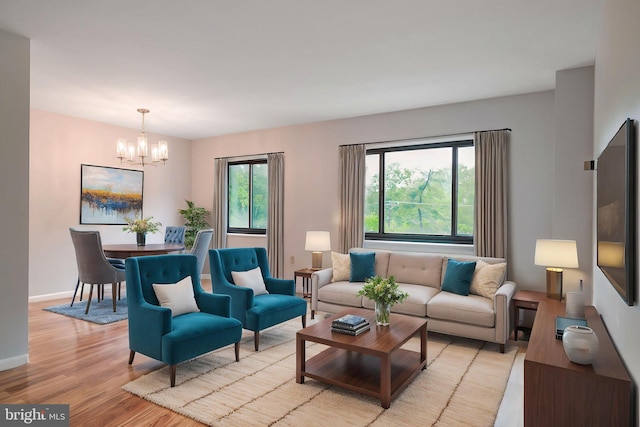 1200 S Arlington Ridge Rd Unit 205, Arlington, VA 22202 - living room featuring a chandelier, light wood-style floors, and baseboards