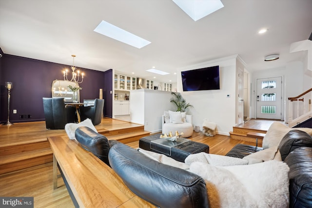 11700 Seven Locks Rd, Potomac, MD 20854 - living room featuring a skylight, a chandelier, wood finished floors, stairs, and baseboards