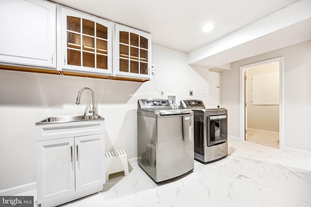 11700 Seven Locks Rd, Potomac, MD 20854 - laundry area featuring cabinet space, washer and clothes dryer, light marble finish flooring, and baseboards