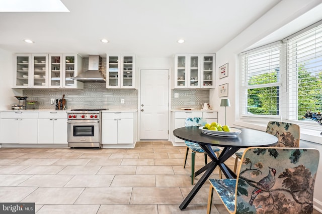 11700 Seven Locks Rd, Potomac, MD 20854 - kitchen featuring wall chimney exhaust hood, luxury stove, plenty of natural light, tasteful backsplash, and recessed lighting