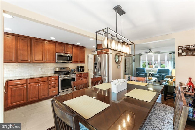 515 Terravilla Ln, Ridley Park, PA 19078 - kitchen featuring stainless steel appliances, a ceiling fan, tasteful backsplash, hanging light fixtures, and light stone counters