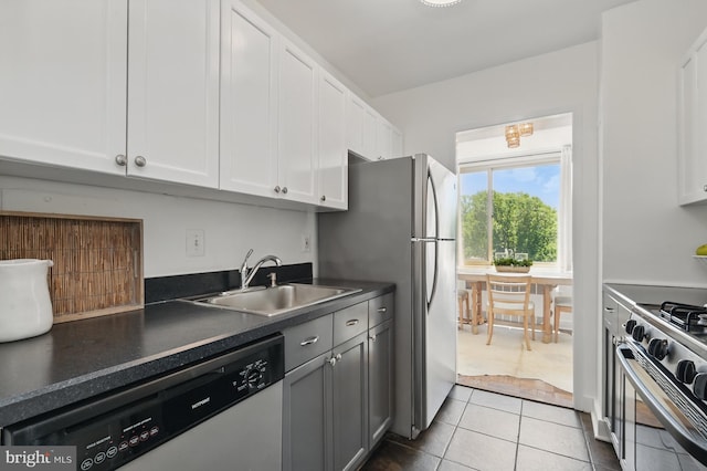 4000 Tunlaw Rd NW Unit 714, Washington, DC 20007 - kitchen with a sink, appliances with stainless steel finishes, white cabinetry, dark countertops, and tile patterned flooring