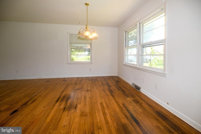 21749 Point Lookout Rd, Leonardtown, MD 20650 - spare room featuring a chandelier, plenty of natural light, wood finished floors, and baseboards