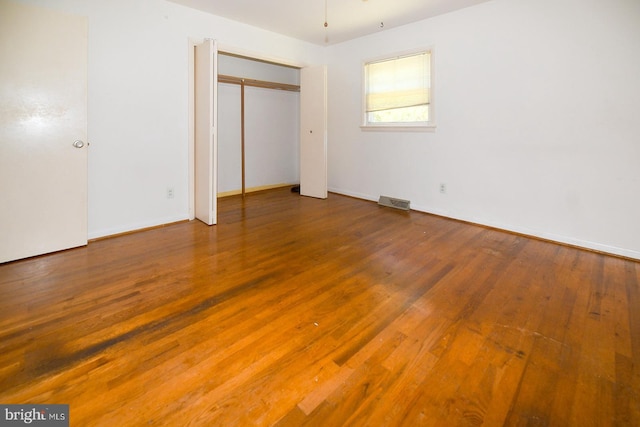 21749 Point Lookout Rd, Leonardtown, MD 20650 - unfurnished bedroom featuring wood finished floors, baseboards, and a closet
