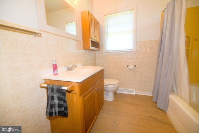 21749 Point Lookout Rd, Leonardtown, MD 20650 - full bath featuring tile walls, wood finished floors, vanity, toilet, and shower / bathtub combination with curtain