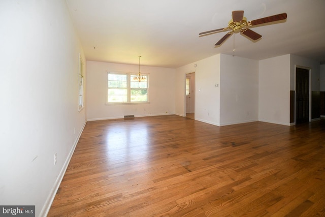 21749 Point Lookout Rd, Leonardtown, MD 20650 - unfurnished room featuring a chandelier, wood finished floors, ceiling fan, and baseboards