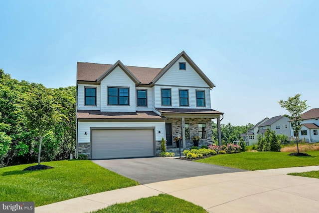 24824 Scarlet Maple Ct, Aldie, VA 20105 - view of front of house featuring driveway, stone siding, a front lawn, a porch, and an attached garage