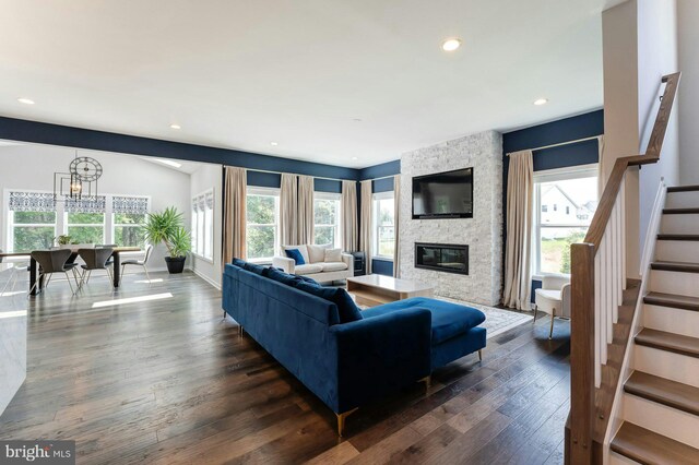 24824 Scarlet Maple Ct, Aldie, VA 20105 - living area with stairs, a stone fireplace, dark wood-type flooring, a chandelier, and recessed lighting
