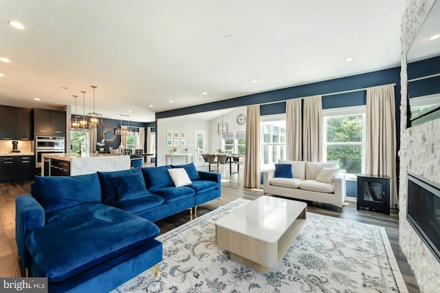 24824 Scarlet Maple Ct, Aldie, VA 20105 - living area with dark wood-style flooring, recessed lighting, a chandelier, and a fireplace