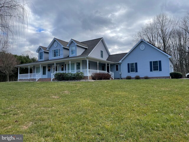 36 Cadwell Ct, Conowingo, MD 21918 - farmhouse-style home with a porch, a front yard, and roof with shingles