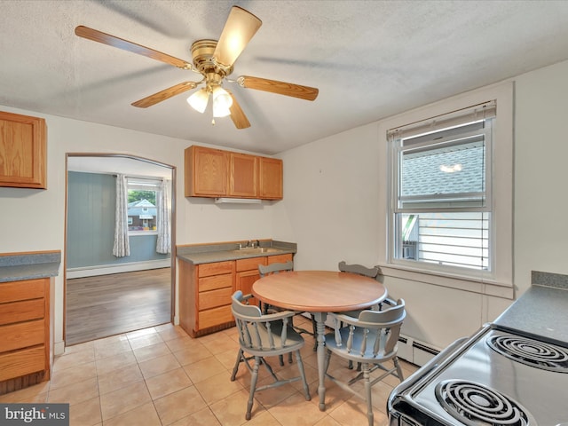 415 Parkway Ave, Schuylkill Haven, PA 17972 - kitchen with ceiling fan, a baseboard heating unit, light tile patterned flooring, a textured ceiling, and black range with electric stovetop
