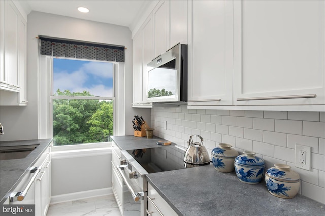 3601 Connecticut Ave NW Unit 816, Washington, DC 20008 - kitchen with white cabinetry, appliances with stainless steel finishes, light marble finish flooring, backsplash, and recessed lighting