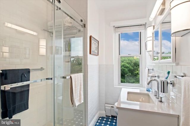 3601 Connecticut Ave NW Unit 816, Washington, DC 20008 - bathroom featuring tile walls, a shower stall, vanity, and wainscoting