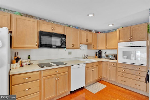108 Kennedy Blvd, Bellmawr, NJ 08031 - kitchen with black appliances, light brown cabinetry, light wood-style flooring, and light countertops