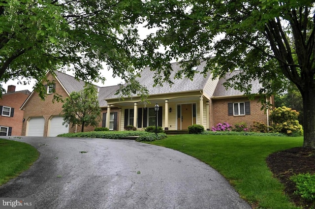 31 Fitzhugh Ave, Westminster, MD 21157 - view of front facade featuring driveway, a front lawn, brick siding, and roof with shingles