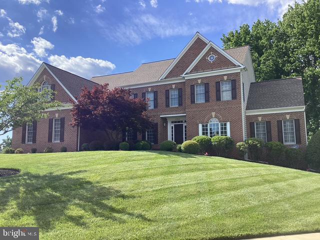 12618 Willow Marsh Ln, Bowie, MD 20720 - georgian-style home featuring a front lawn and brick siding