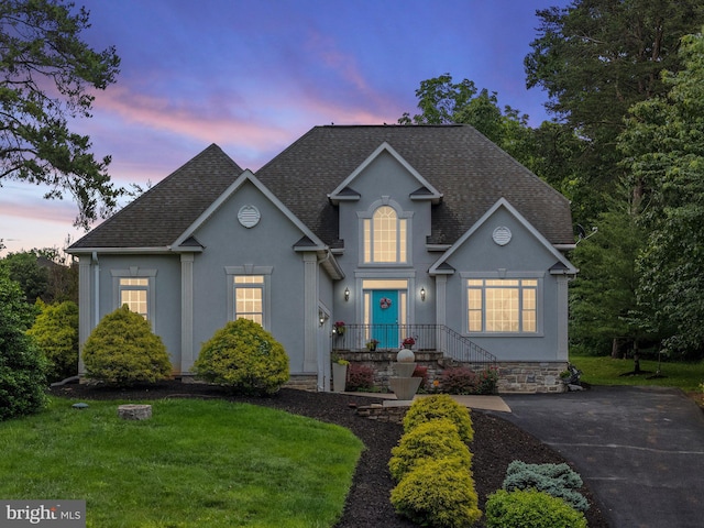 1399 N Royal Ave, Front Royal, VA 22630 - traditional-style house featuring a shingled roof, stucco siding, and a front yard