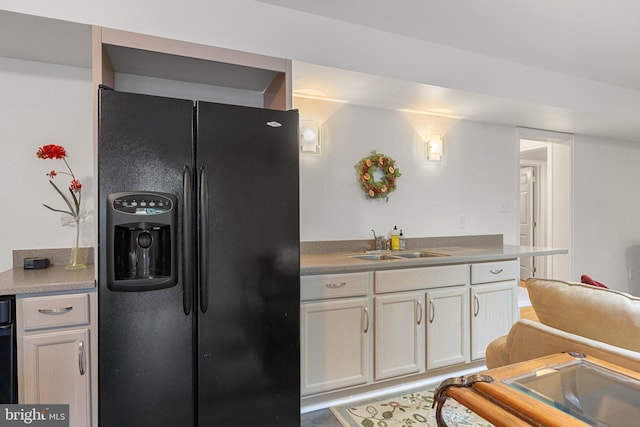 1399 N Royal Ave, Front Royal, VA 22630 - kitchen featuring black fridge, a sink, and white cabinetry