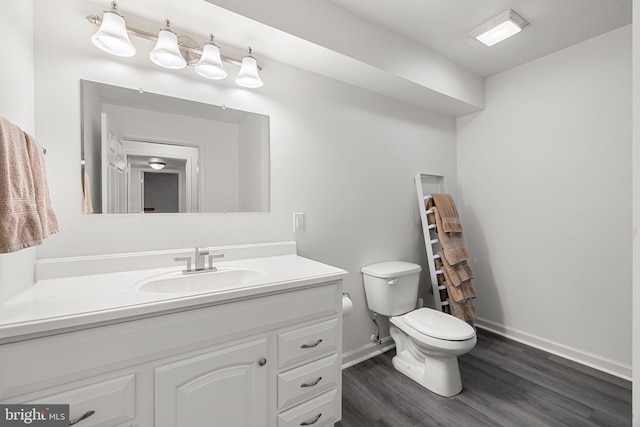 1399 N Royal Ave, Front Royal, VA 22630 - bathroom featuring toilet, vanity, wood finished floors, and baseboards