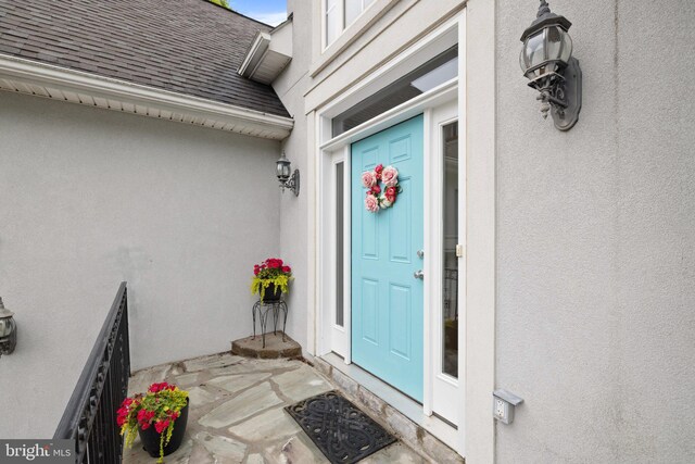 1399 N Royal Ave, Front Royal, VA 22630 - view of exterior entry featuring a shingled roof and stucco siding