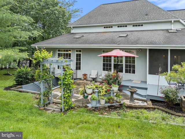 1399 N Royal Ave, Front Royal, VA 22630 - rear view of house featuring roof with shingles, a lawn, stucco siding, and a sunroom