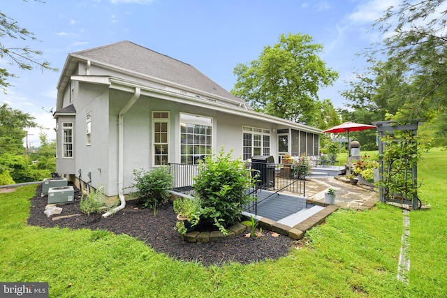 1399 N Royal Ave, Front Royal, VA 22630 - back of house with stucco siding, a lawn, a patio area, and roof with shingles