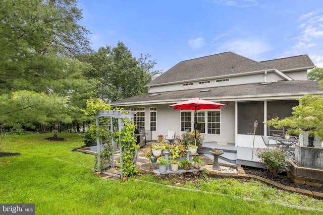 1399 N Royal Ave, Front Royal, VA 22630 - back of house with a shingled roof, a lawn, a patio, stucco siding, and a sunroom