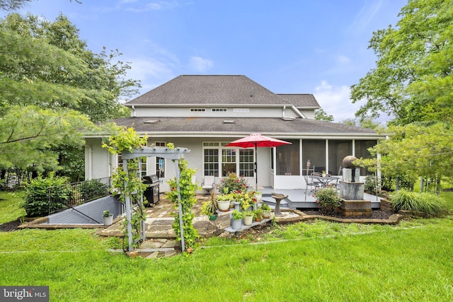 1399 N Royal Ave, Front Royal, VA 22630 - rear view of property featuring a lawn, a sunroom, a patio area, roof with shingles, and stucco siding