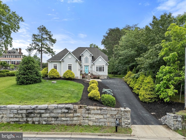 1399 N Royal Ave, Front Royal, VA 22630 - traditional-style house featuring stucco siding, a front yard, driveway, and roof with shingles