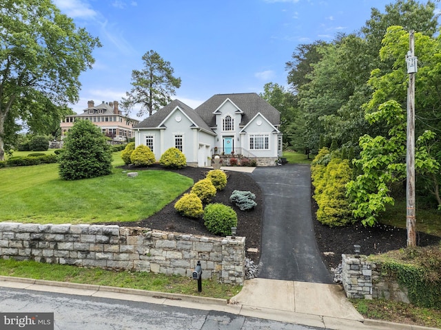 1399 N Royal Ave, Front Royal, VA 22630 - traditional home with asphalt driveway, a front yard, stucco siding, and an attached garage