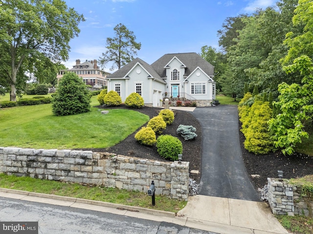 1399 N Royal Ave, Front Royal, VA 22630 - traditional home featuring a front yard, stucco siding, driveway, and a garage