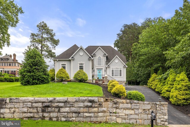 1399 N Royal Ave, Front Royal, VA 22630 - traditional-style house featuring a front lawn, stucco siding, and a shingled roof