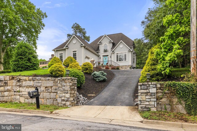 1399 N Royal Ave, Front Royal, VA 22630 - traditional-style home with driveway, stucco siding, a garage, and a shingled roof