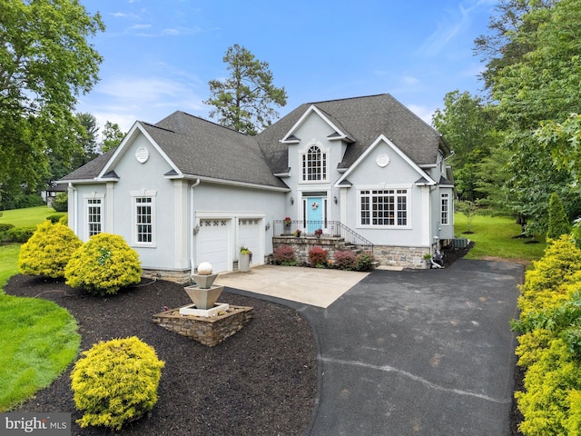 1399 N Royal Ave, Front Royal, VA 22630 - traditional home featuring asphalt driveway, an attached garage, roof with shingles, and stucco siding