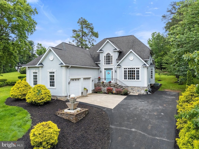 1399 N Royal Ave, Front Royal, VA 22630 - traditional-style home with roof with shingles, a garage, driveway, and stucco siding
