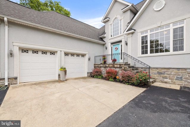 1399 N Royal Ave, Front Royal, VA 22630 - view of front of home with stucco siding, driveway, a shingled roof, a garage, and stone siding