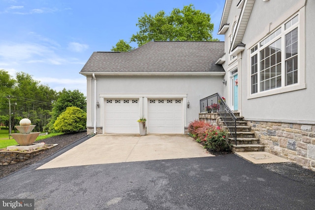 1399 N Royal Ave, Front Royal, VA 22630 - view of home's exterior with concrete driveway, an attached garage, and stucco siding