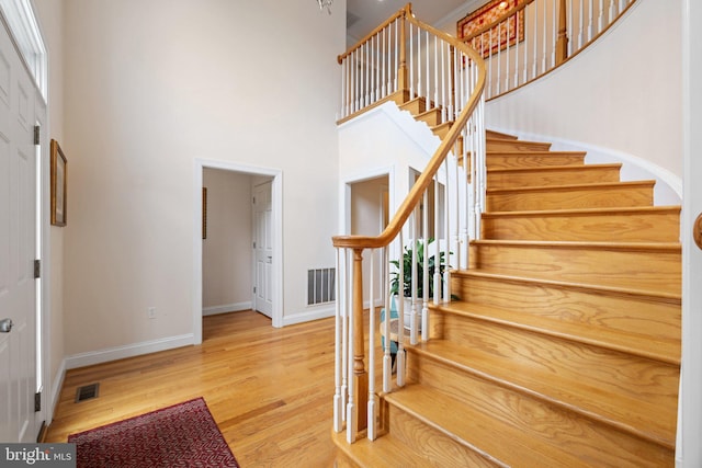 1399 N Royal Ave, Front Royal, VA 22630 - foyer featuring baseboards, stairs, a high ceiling, and wood finished floors