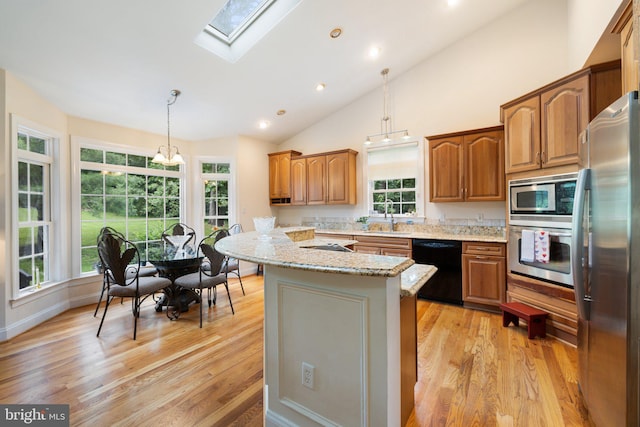 1399 N Royal Ave, Front Royal, VA 22630 - kitchen featuring black appliances, light wood-style flooring, light stone countertops, a skylight, and recessed lighting