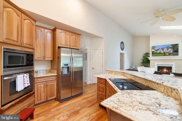 1399 N Royal Ave, Front Royal, VA 22630 - kitchen featuring stainless steel appliances, light wood-type flooring, light stone countertops, and ceiling fan