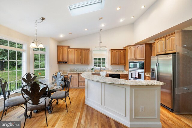 1399 N Royal Ave, Front Royal, VA 22630 - kitchen featuring stainless steel appliances, a center island, healthy amount of natural light, light stone countertops, and lofted ceiling