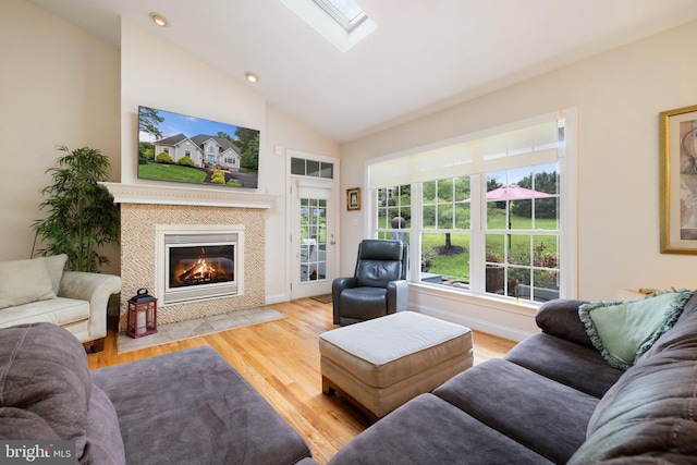 1399 N Royal Ave, Front Royal, VA 22630 - living area featuring a skylight, wood finished floors, a tiled fireplace, recessed lighting, and high vaulted ceiling