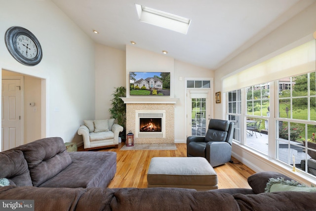 1399 N Royal Ave, Front Royal, VA 22630 - living room featuring healthy amount of natural light, high vaulted ceiling, a fireplace with flush hearth, wood finished floors, and baseboards