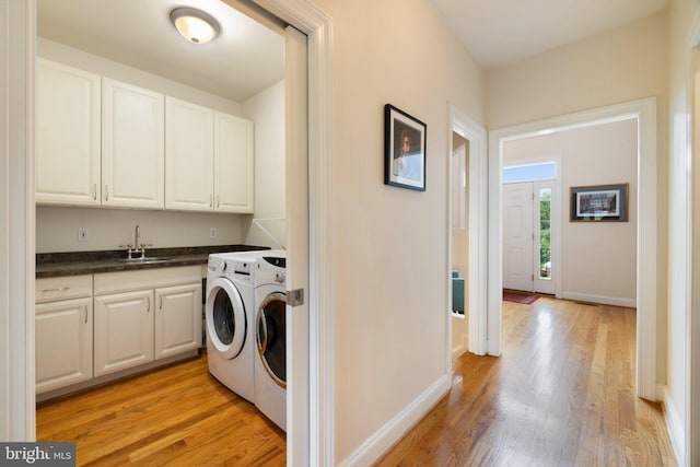 1399 N Royal Ave, Front Royal, VA 22630 - washroom featuring washer and clothes dryer, light wood-type flooring, cabinet space, and baseboards