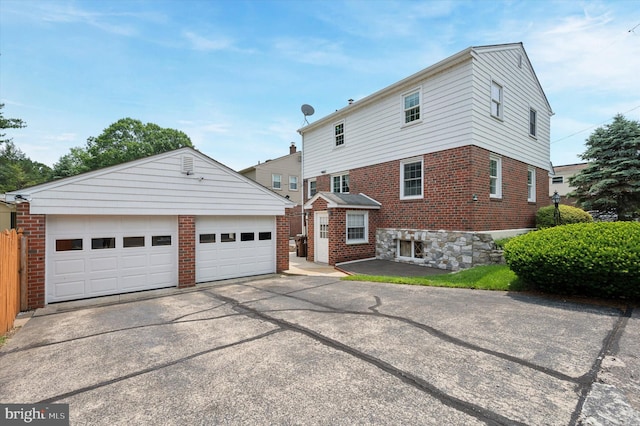 167 Eldon Ave, Lansdowne, PA 19050 - view of front of house featuring brick siding, an outdoor structure, and a garage