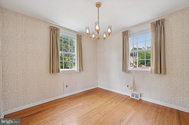 167 Eldon Ave, Lansdowne, PA 19050 - empty room featuring light wood-style flooring, a chandelier, baseboards, and wallpapered walls