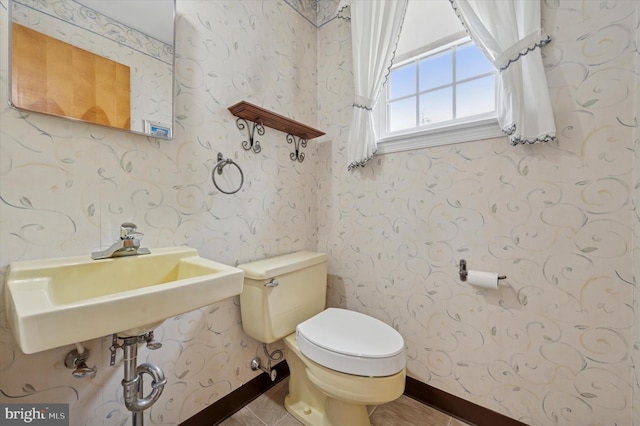 167 Eldon Ave, Lansdowne, PA 19050 - bathroom featuring toilet, a sink, wallpapered walls, baseboards, and tile patterned flooring
