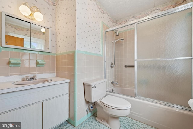 167 Eldon Ave, Lansdowne, PA 19050 - full bath featuring toilet, wallpapered walls, tile walls, vanity, and combined bath / shower with glass door